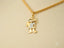 Gold Doll Pendant showcases a cartoon boy character in 18k gold with diamond accents