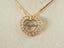 Gold heart-shaped Jesus pendant in 18k gold with diamond accents on a delicate chain