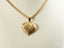18k gold heart pendant on a delicate chain necklace, featuring a beautiful golden heart