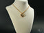 Gold heart pendant necklace in 18k gold featuring a delicate chain design