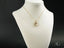 18k Gold heart pendant necklace on a white jewelry bust showcasing golden heart design
