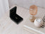 18k gold heart pendant displayed in a black velvet jewelry box with a ring