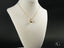 Elegant 18k gold heart pendant necklace on a white bust showcasing Golden Heart design