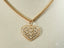 Gold-toned heart pendant necklace with filigree pattern from Golden Hearts collection in 18k gold