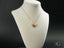 18k gold elephant pendant necklace on a delicate chain featuring a golden love heart design