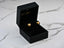 Gold heart earrings in a black jewelry box showcasing 18k gold heart design