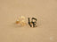 Gold and black LOVE stud earrings in radiant 18k gold for elegant art gold jewelry