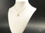 18k Gold necklace with CZ Mom Pendant displayed on a white jewelry bust for Golden Love