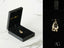 Gold-colored 18k gold Mom Pendant featuring a globe design in a black jewelry box