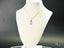 Gold necklace featuring a boy-shaped pendant, from the Golden Play collection