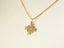 Gold-colored puzzle piece pendant on a delicate chain for Autism Awareness in 18k gold
