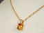 Gold-toned Golden Radiance Pendant with amber crystal and diamond accent on 18k gold chain