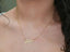 Golden Signature Necklace with customizable name plate in gold.