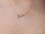 Golden Signature Necklace with customizable name plate in gold, worn around the neck.