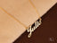 Golden Signature Necklace with custom name plate in 18k gold on elegant boxer chain.