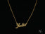 Golden Signature Necklace with custom name plate in 18k gold on boxer-style chain.