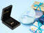 Golden Signature Necklace with customizable name plate in elegant box, surrounded by gift packaging.