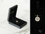 Circular 18k gold Golden Spark Pendant with blue center stone and cubic zirconia gems
