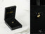 Gold spherical pendant in a black jewelry box, showcasing an elegant 18k gold design