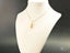 18k gold Golden Steps Shoes Pendant showcased on a white jewelry bust