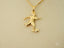 Gold pendant of a soccer player in action, part of the Golden Striker collection