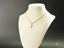 18k gold Golden Treasure Pendant on a white jewelry bust showcasing elegance