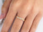 Gold ring with white gemstones in floral pattern, showcasing 18k yellow gold elegance