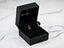 Black jewelry box showcasing 18k Gold Ladybug Earrings that bring good luck