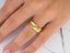 Gold Luminous Path Wedding Band in 14k gold with engraved text on a finger