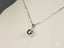 Silver pendant necklace with a spherical charm in 18k white gold, named Luminous Sphere
