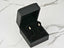 Gold stud earrings in a black jewelry box for Lustrous Harmony 18K Gold Pearl Drop Earrings
