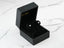 Silver stud earrings elegantly displayed in a black jewelry box for LuxeSphere 18K gold jewelry