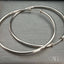 Luxury 18k white gold hoop earrings showcasing minimalist design and elegance.