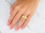 Gold ring with engraved design showcasing the Majestic Weave Wedding Band in 14k gold