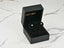 Black jewelry box displaying Midnight Elegance black pearl stud earrings