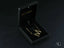 Gold earrings in a black jewelry box with personalized initial letter pendant necklace
