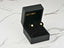 Gold stud earrings in a black jewelry box showcasing Petal Pearl 18K Yellow Gold design