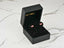 Pink bow earrings in a black jewelry box of 18K Gold Pink Bow Earrings charm