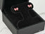 Pink bow earrings in a black jewelry box, showcasing 18K Gold Pink Bow Earrings
