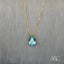 Gold necklace featuring a teardrop-shaped blue topaz pendant and 18 carat gold chain