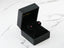 Black jewelry box showcasing Radiant Glow 18k White Gold CZ stud earrings with ruby accents