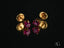Gold and ruby stud earrings featuring ruby-red cubic zirconia in heart design