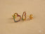 Gold heart-shaped stud earrings featuring rainbow CZ stones in vibrant colors