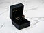 Heart-shaped earrings in a black box featuring multicolor heart CZ stones in art gold jewelry