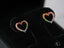 Heart-shaped gold earrings featuring multicolor CZ stones in a vibrant design