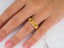 Gold 14k Regal Ridge Wedding Band with a textured ribbed design worn on a finger
