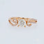 Romantic 18k rose gold diamond ring with 0.5 ct diamond centerpiece and intricate design.