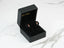 Rose stud earrings in a black jewelry box, showcasing a gold delicate rose design