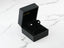 Crown-shaped stud earrings in a black box, featuring 18K white gold design