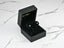 Open black jewelry box displaying 18k Gold Sapphire Stud Earrings with oval-cut sapphires